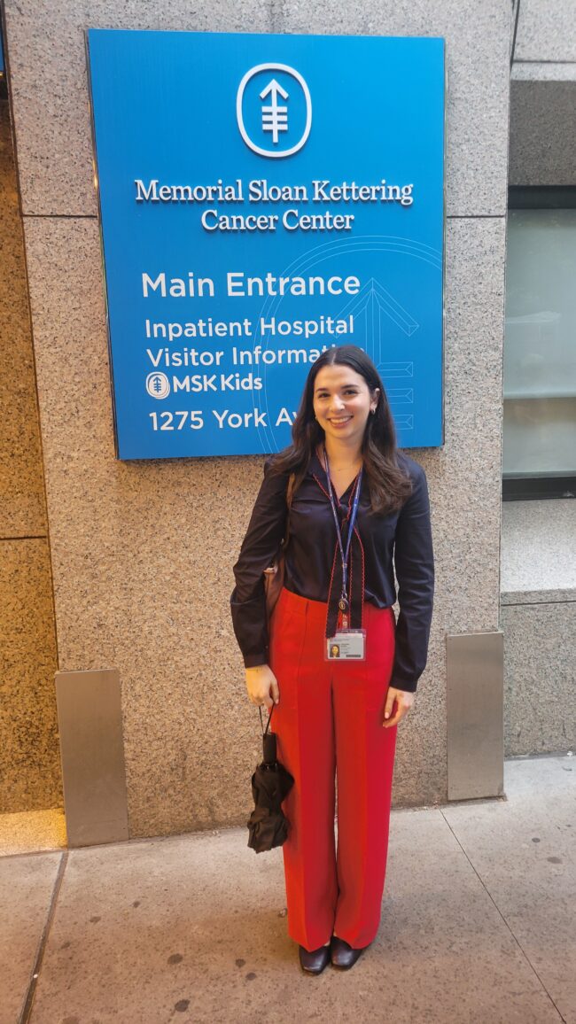 Woman in front of sign for Memorial Sloan Kettering
