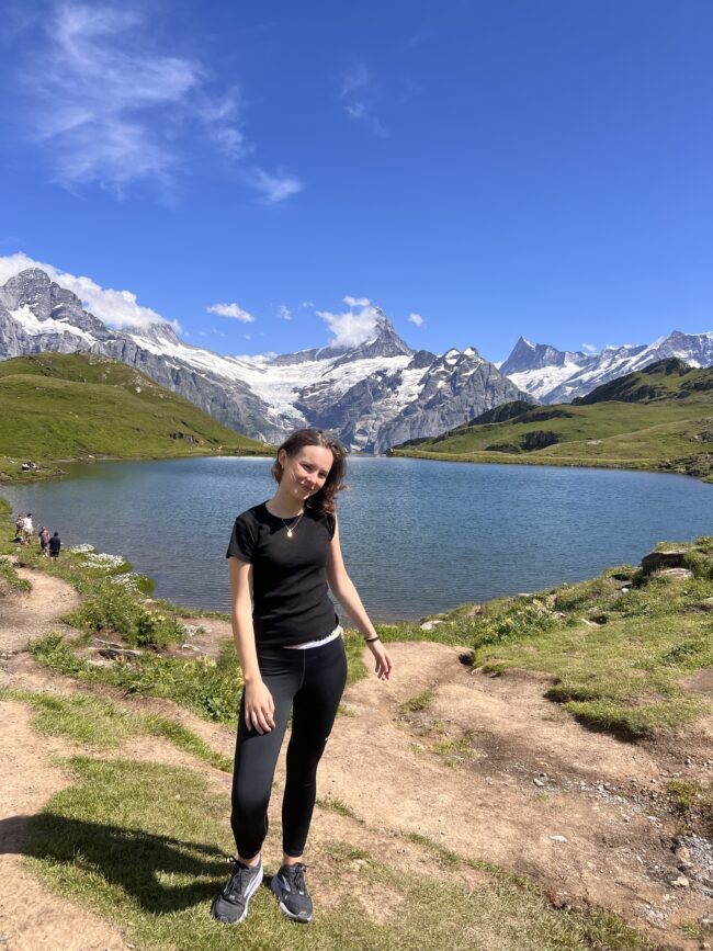 Woman in front of mountain and lake