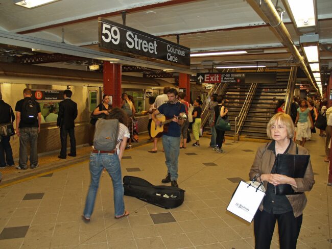 A photo of commuters on the subway platform at 59th st-Columbus Circle