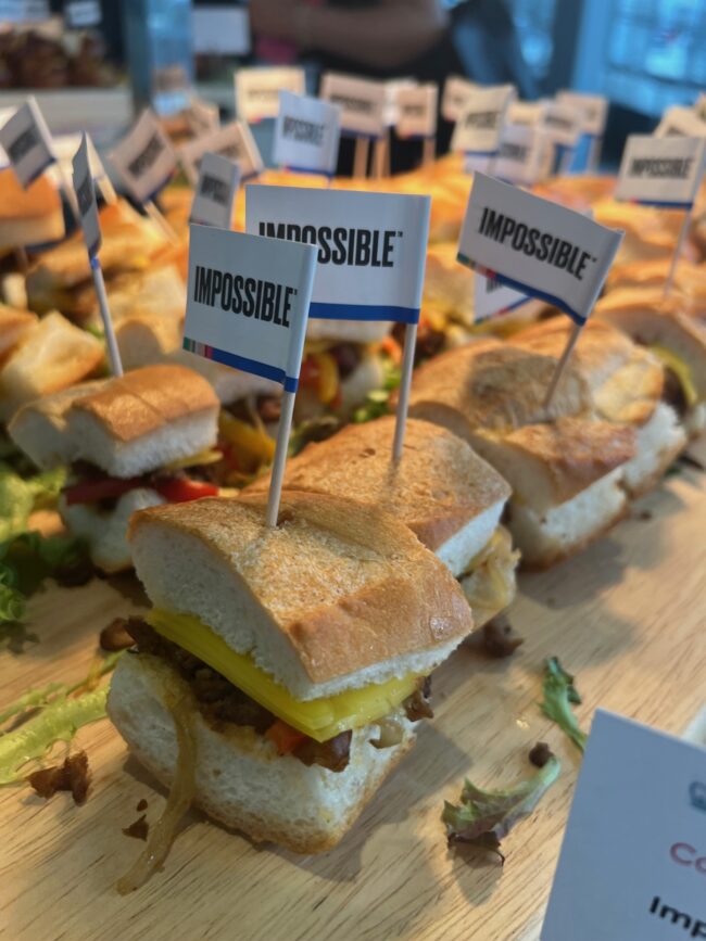 Many small sandwiches, made with Impossible plant-based foods, on a platter