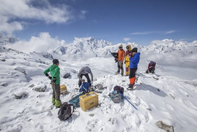 Scientists with tools on glacier
