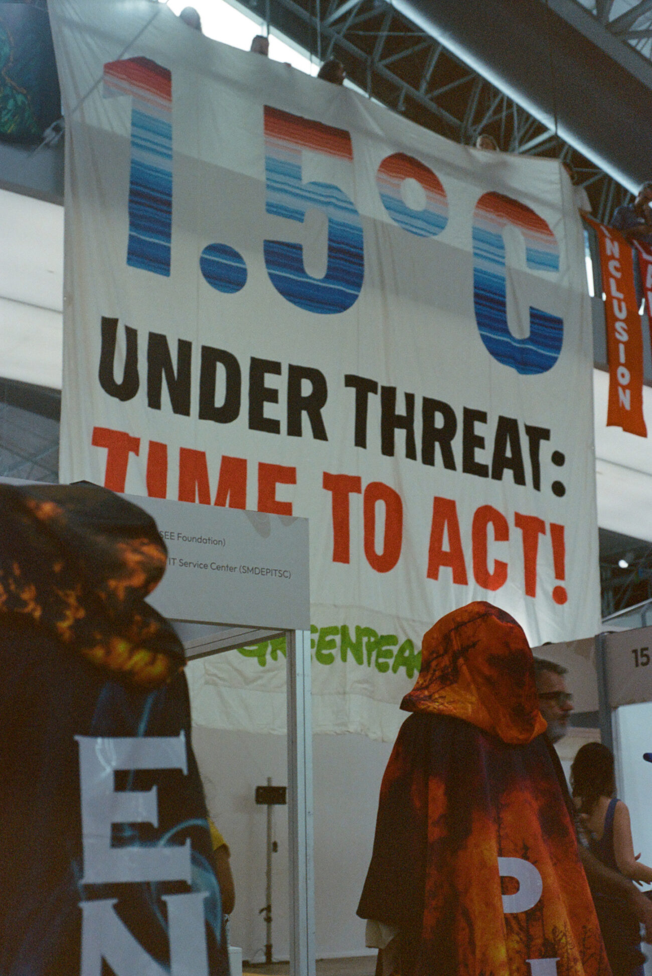 Time to Act sign and protesters at COP30