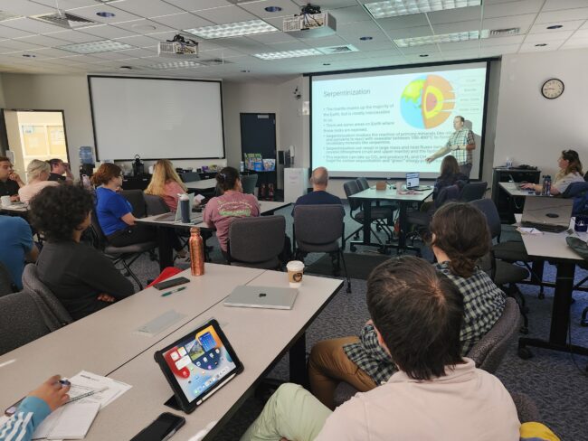 A researcher giving a presentation to teacher participants