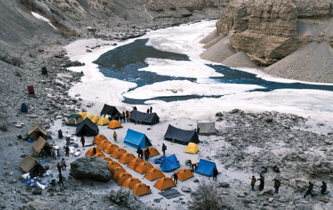 Tourists and porters camping on the banks of the frozen Chadar River