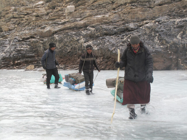 Guides tap the ice with a walking stick