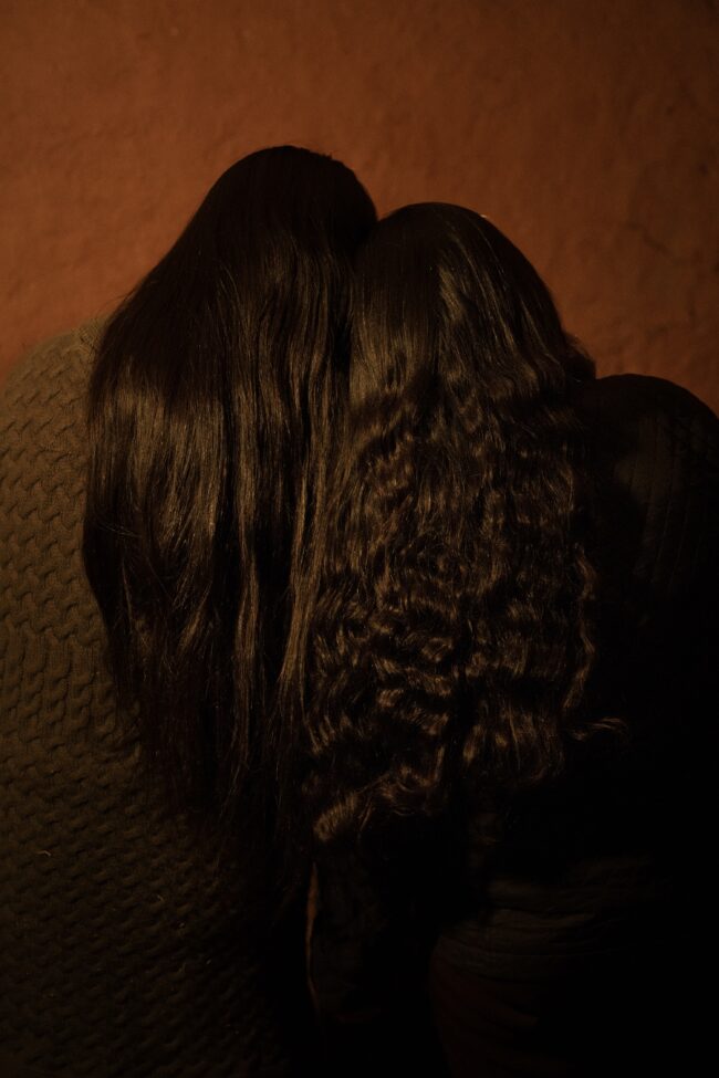 Mother and daughter join heads as a symbol of connection