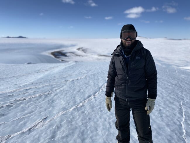 Austin Carter standing on a field of blue ice