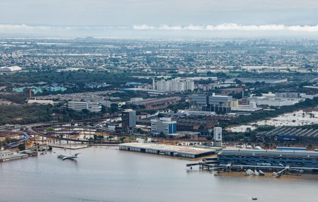 Flooding surrounds an airport, leaving many planes submerged in brown water