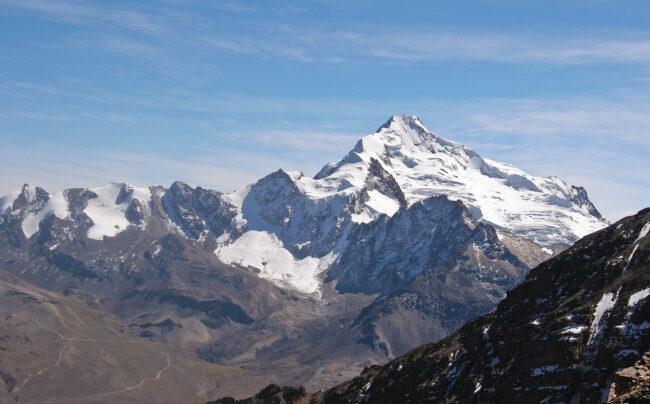 Snow-covered mountain peak under a blue sky