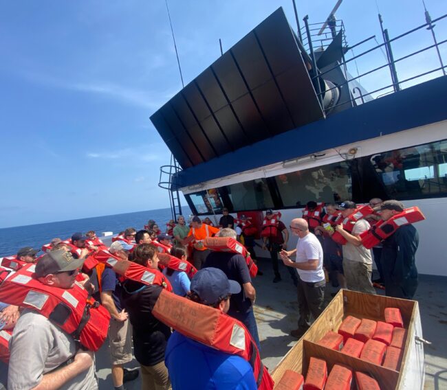 Safety drill with all passengers and crew members aboard research ship