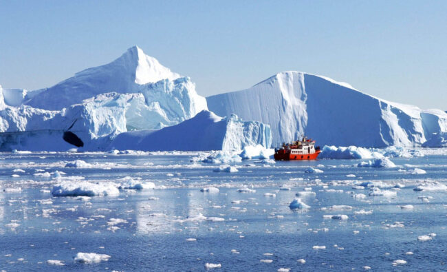 Greenland’s retreating ice sheet with a red ship in front