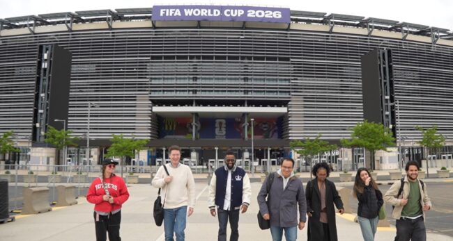 Group of people walking outside a stadium with a FIFA World Cup 2026 sign