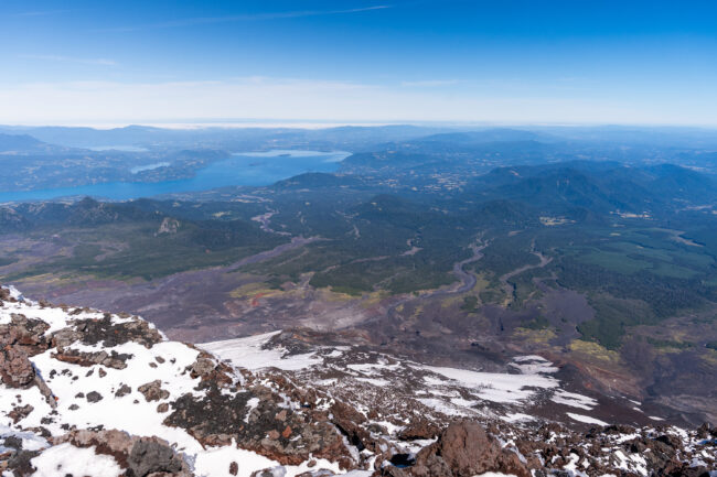 Lahars are fast moving flows of  water, mud and rock. This photo, taken on the southwest side of the rim shows the distance travelled by lahars from a prior eruption. Lake Calafquén is in the distance, approximately 10 miles away. Photo by Francesco Fiondella.
