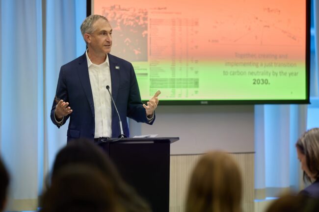 Photo of the mayor of Ann Arbor in front of a screen