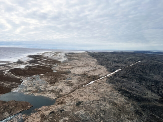 The end of a glaciation. Prominent trimline marks the 1960 extent of the Barnes Ice Cap. The dark colored landscape hosts mature vegetation and lichen cover, whereas the light-colored rock is vegetation free. Ice margin retreat from this trimline has reversed ~2,000 years of ice margin expansion. 