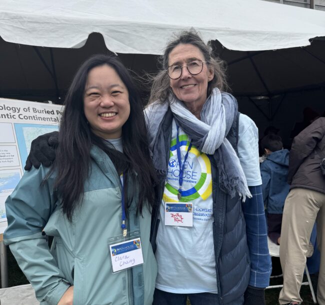 Dorothy Peteet and Clara Chang smile in front of a poster